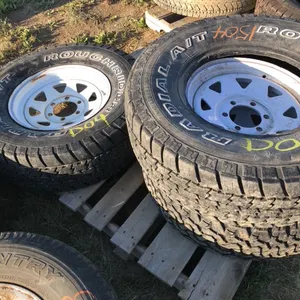Three truck tires on trailer rims