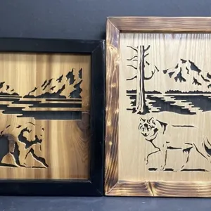 Two handcrafted wooden scrolled wall hangings.