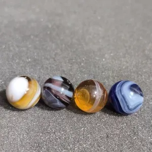 4 opaque and clear marbles with single pontil
