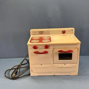 CHILD'S TIN STOVE WITH CORD
