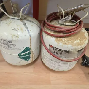 Two Propane Tanks with Attached Hoses and Spray Nozzle