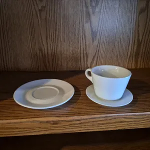 (12) Lavazza Coffee Mugs, (14) 4-3/4" Ceramic Saucers, (11) 6-1/2" Ceramic Saucers