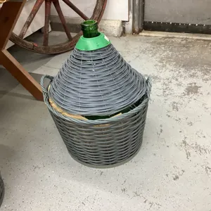 LARGE ROUNDED GREEN DEMIJOHN CARBOY IN  BASKET