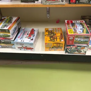 SHELF OF ASSORTED MODEL CARS INCLUDING; AMI 1964 CONVERTIBLE CUSTOMIZING KIT, AMI 1923 T DEPOT HACK,