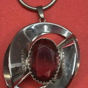 Silver Coloured Circle Pendant w/Purple Stone.
