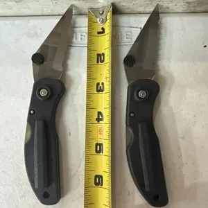 2 Black folding lock knives with serrated blade