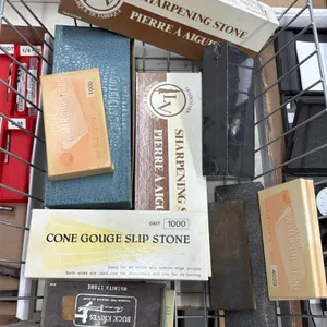 BIN OF ASSORTED SHARPENING STONES & SLIP STONES