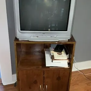 RCA TV with wooden TV stand and contents