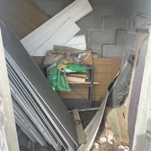 Contents of shed -  screen doors,broom, shovel