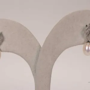 10kt white gold and fresh water cultured pearl earring set with single cut round diamonds. Retail re