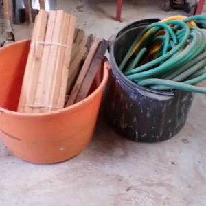 2- tubs of wood stakes & garden hose