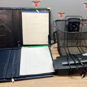 2 Portfolio folders, paper, shredder, and basket.