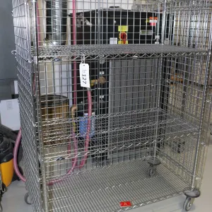 Heavy duty two door, lockable cabinet on castors, two shelves, 68"h x 49"w x 25"d.
