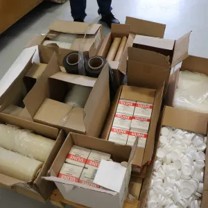 Pallet lot of items including plastic sleeves, tube end caps, thousands of Uline S-5863 hanging tabs