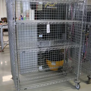 Heavy duty two door, lockable cabinet on castors, two shelves, 68"h x 49"w x 25"d.