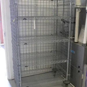 Heavy duty two door, lockable cabinet on castors, three shelves, 68"h x 38"w x 24"d.
