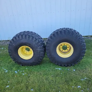 Lot 8. (3) JD tires and rims, came off of JD 777, one is very good, other two questionable but hold air (weather checked, etc) these would possibly fi