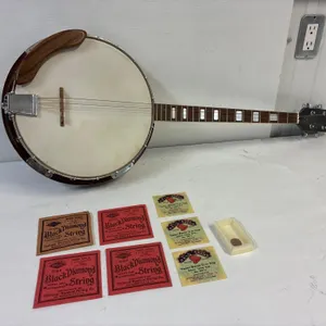 Raven Banjo with extra stings and picks