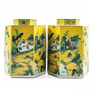 A PAIR OF 'FAMILLE JAUNE' HEXAGONAL JARS W COVERS