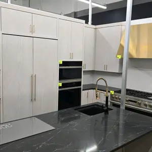 Package lot including Kraftmaid wood cabinets and a Monogram ZIF241NPNAII built-in refrigerator/freezer. Cabinets feature solid surface tops and soft-