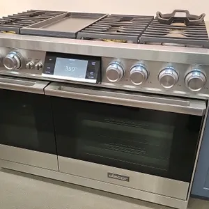 2023 Dacor DOP48C96DLS dual fuel range. Features 6 burners with cast iron grates, 12" skillet, 12" steam oven, and 30" baking oven. Stainless steel fi