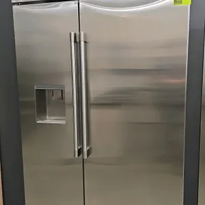 Monogram ZISS480DNGSS side-by-side refrigerator and freezer. Features stainless steel finish, exterior ice and water dispenser, digital controls, and 
