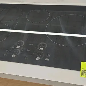 Monogram ZHU30RDTBB induction cooktop. Features a 30" 4-element glass top with touch controls, Sync Burners, and WiFi and Bluetooth connectivity.