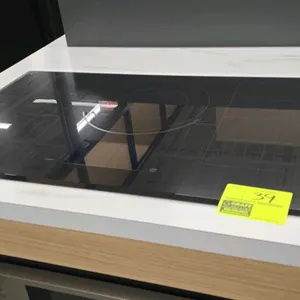 Dacor DT36M977BB induction cooktop. Features a black glass surface and touch controls. 36"W.