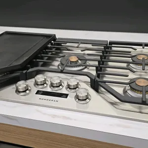 Monogram ZGU36ESLSS 5-burner gas cooktop. Features a stainless steel finish, continuous cast-iron grates, removable griddle, center power boil burner,