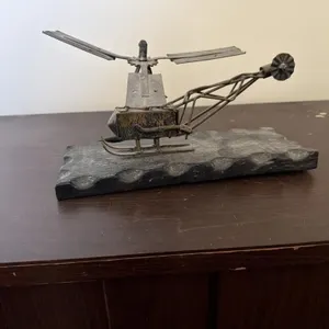 a vintage metal sculpture of a helicopter