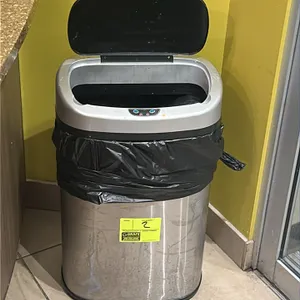 Automatic trash can. Features a stainless steel body and sensor-operated lid. 2'H.