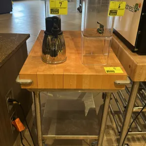 Wood top baker's cart. Features a thick butcher block style wood top, corner bumpers, and a stainless steel undershelf. 30"W x 24"D x 36"H. Mounted on