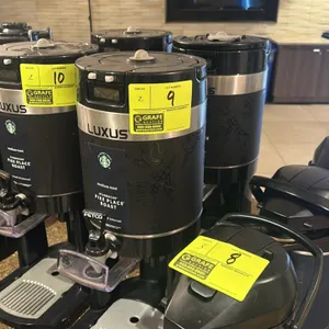 Fetco Luxus hot beverage dispenser. Features a digital display, manual dispense lever, and a removable drip tray.