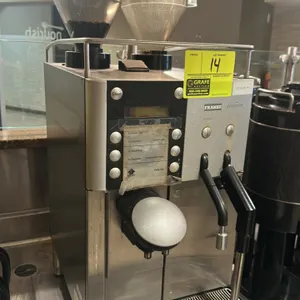 Franke Evolution commercial espresso machine. Features dual bean hoppers, digital display, push-button controls, and steam foamer. Stainless steel fin