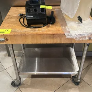 Bakers cart. Features a wood top with corner bumpers and a stainless steel undershelf. 30"W x 24"D x 36"H. Mounted on casters. Contents not included.