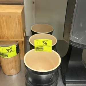 Ceramic kitchenware storage bowl. Features black exterior finish. Includes (3) total bowls.