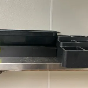 Assorted poly organization trays. Features black plastic construction. Includes multi-compartment organizers and rectangular pans.