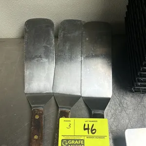 Metal spatula. Features a riveted wood handle.