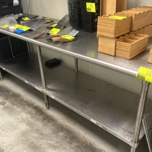 Stainless steel prep table. Features a flat top and a stainless steel undershelf. Mounted on (6) tubular legs with adjustable bullet feet. 8'L x 2.5'D