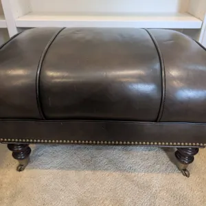 Chocolate Genuine Leather Ottoman With Nailhead Trim and Wooden Turned Legs