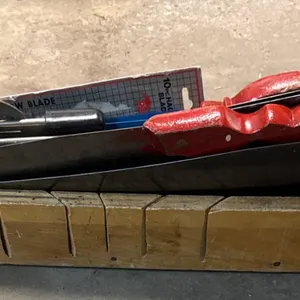 Handsaws with Red Wooden Handles and Sawing Block
