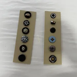 12 black glass buttons including medium tingue