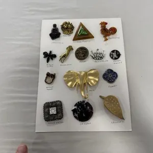 card of 15 trims including bakelite rooster
