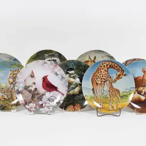 EDWIN M KNOWLES WILDLIFE AND NATURE-THEMED PLATES IN ORIGAMI BOXES.