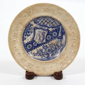ALPHABET PLATE WITH BLUE TRANSFERWARE DESIGN.