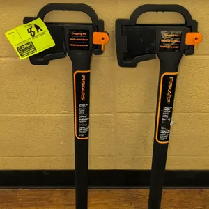 Fiskars chopping axe. Features a black and orange handle. Includes a plastic blade cover with a carrying handle.