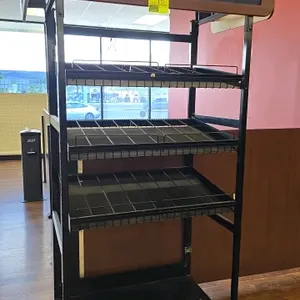 Metal end cap merchandiser. Features a black frame, (3) angled wire shelves, a solid base, and Pepsi header signs. 42"W x 24"D x 84"H.