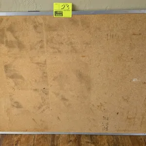 Cork board. Features a metal frame. 4'L x 3'H.