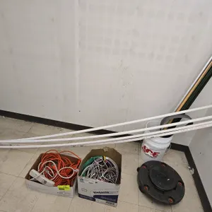 Mixed lot of hardware and electrical supplies. Includes assorted electrical wire, extension cords, power strip, PVC tubing, metal fence stakes, extend