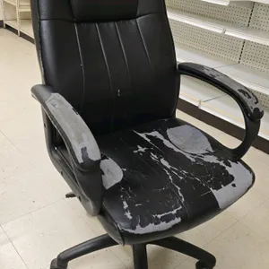 Faux leather office chair. Features a high back and armrests. Mounted on a 5-star base with casters. Note: faux leather upholstery is heavily peeling 